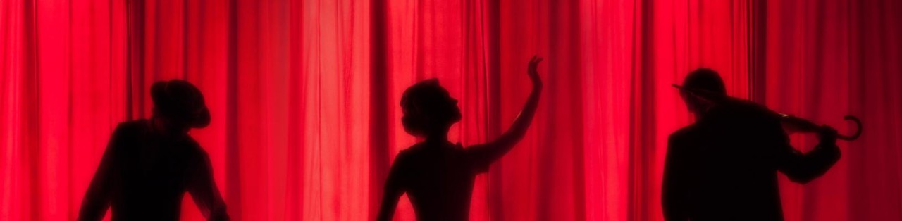 Actors and red curtain