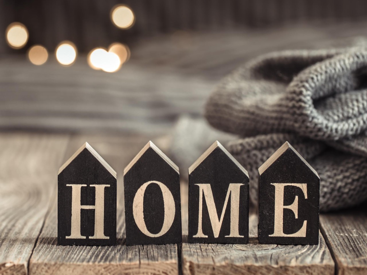 Woden blocks shaped as houses, saying "home"